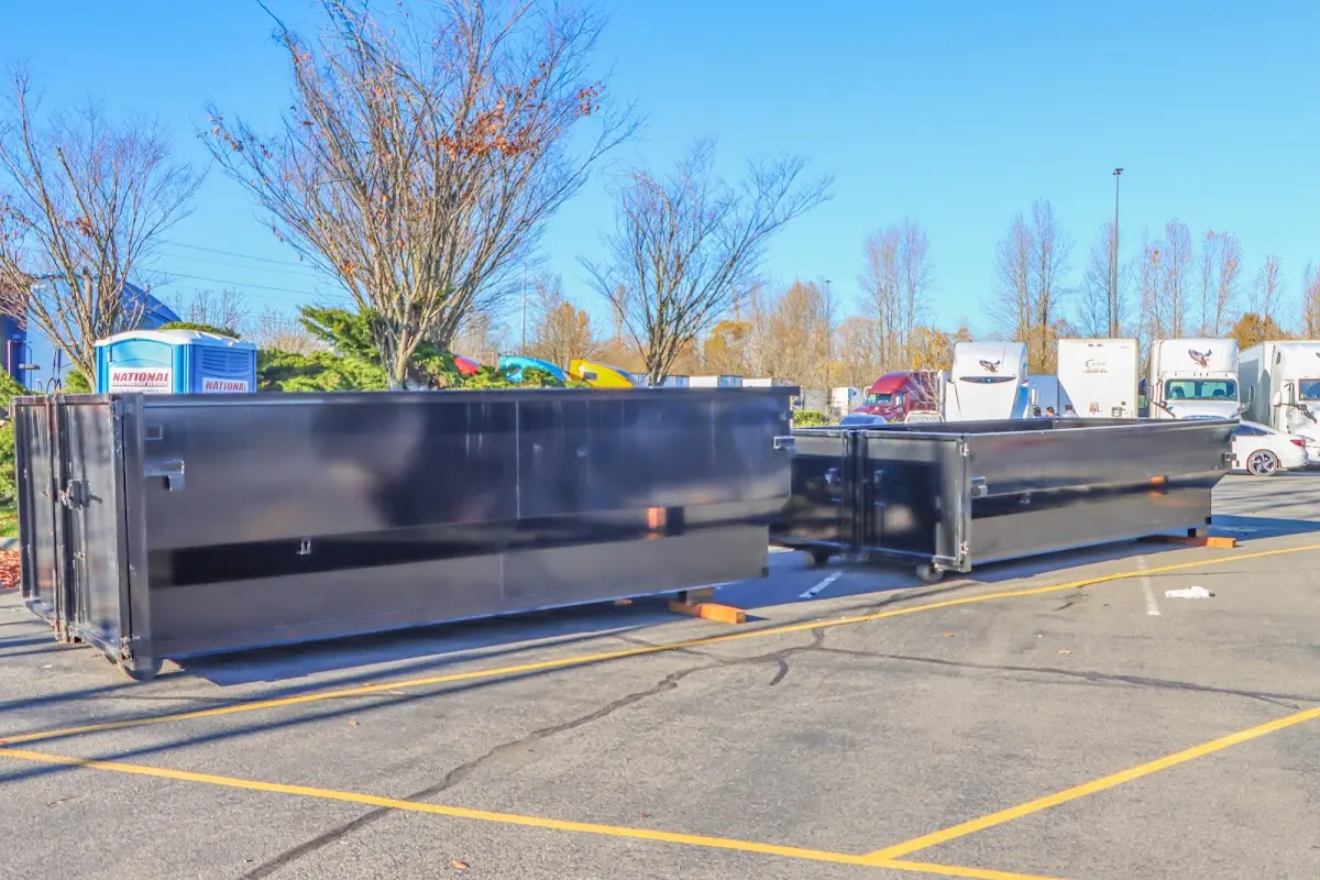 Professional dumpster rental service with roll-off container on residential driveway in Lely Resort